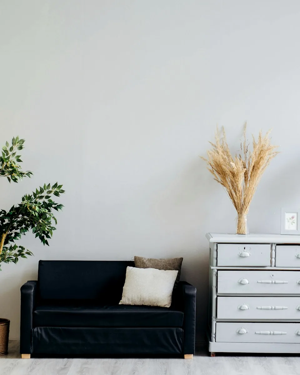 Minimal interior vignette with pampas stems and a quiet credenza