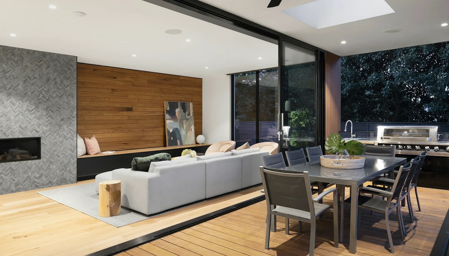 Open-plan kitchen and dining area flowing to a landscaped courtyard