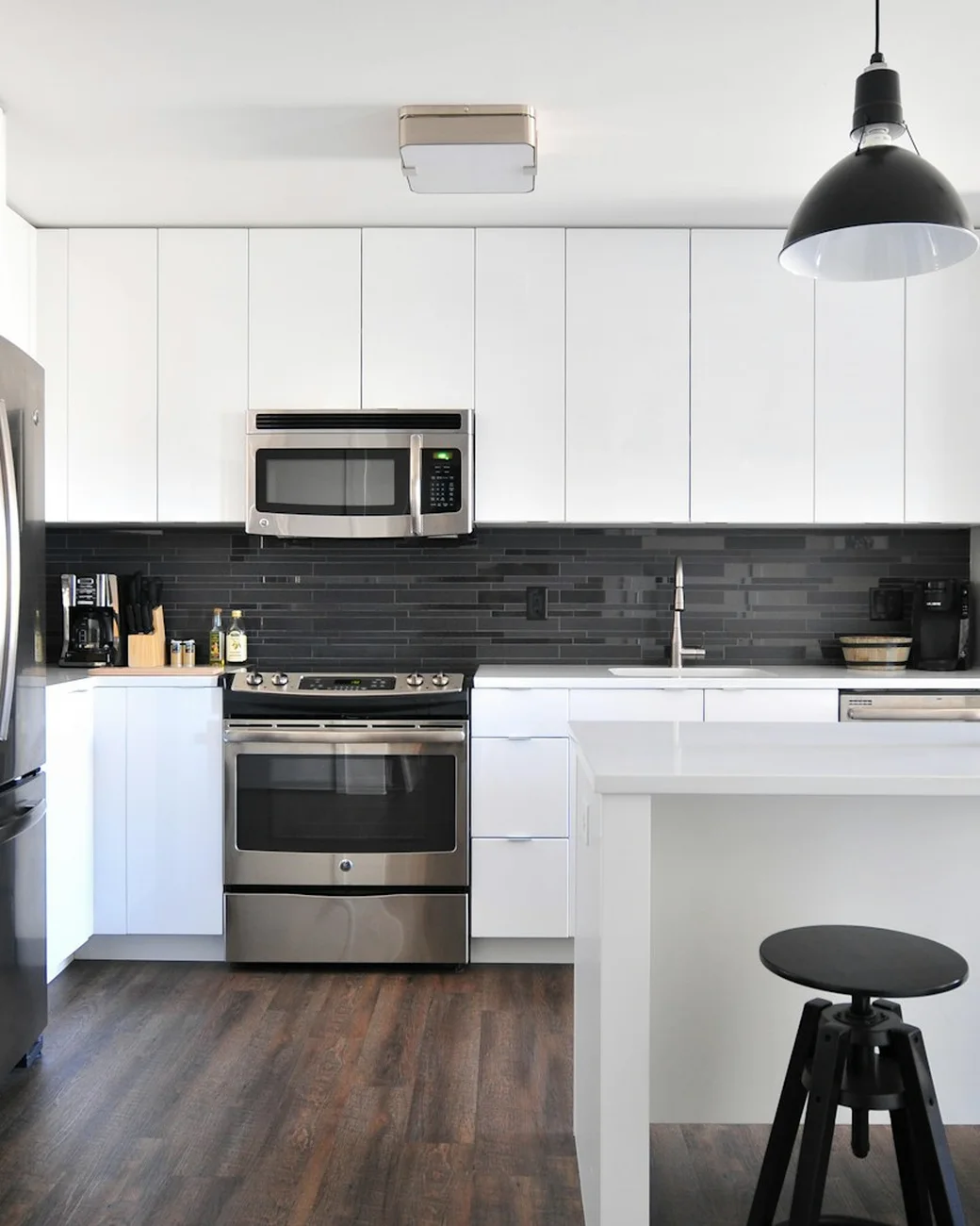 Bright kitchen with pale cabinetry, open shelving and timber accents