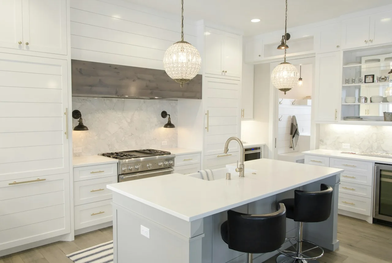 Bright joinery detail with white cabinetry and textured plaster surround