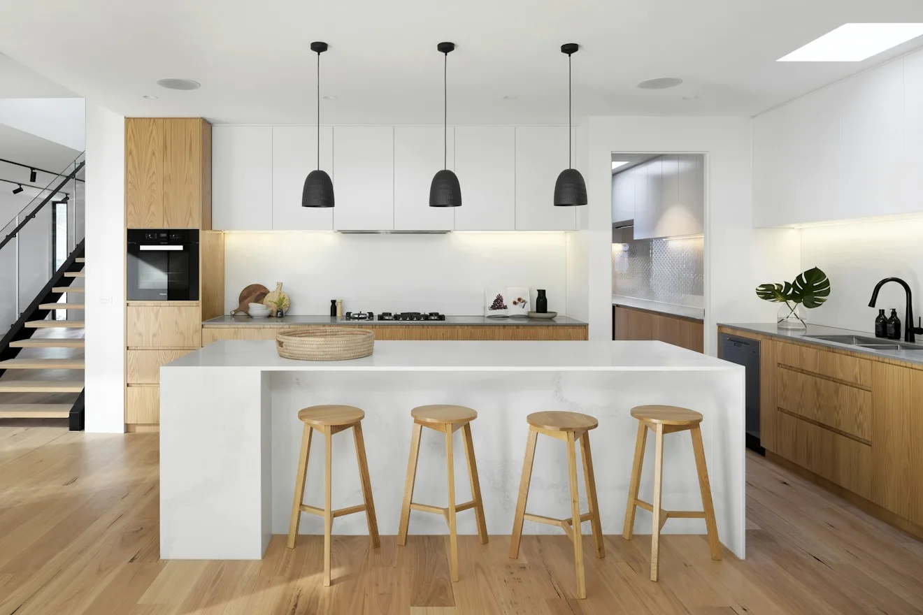 Contemporary kitchen with island bench, timber stools and pendant lighting